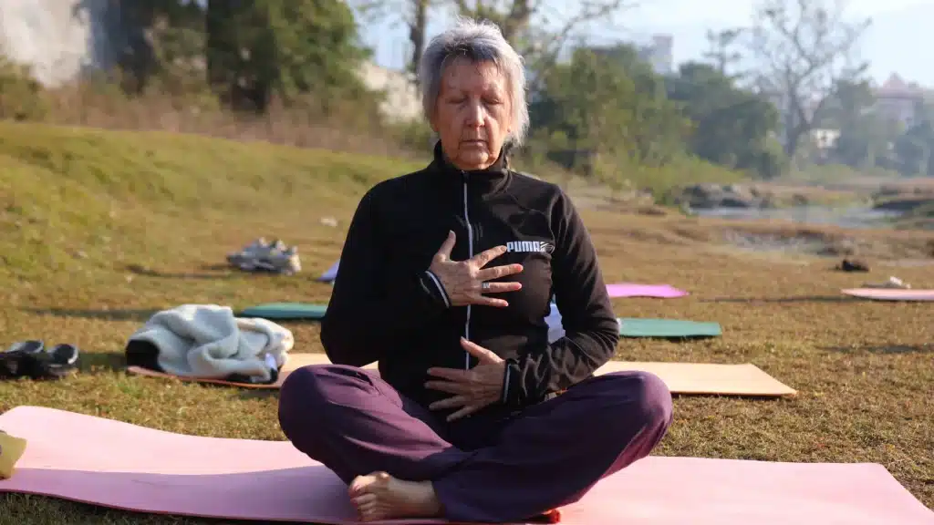 Exploring the Connection Between Dosha, Prakriti, and Emotional Wellness 2 Yan Cure guest practising breath awareness for emotional wellness outdoors in Rishikesh
