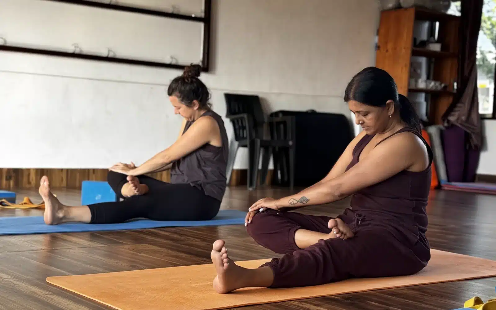 Mindful yoga practice supporting dosha balance and emotional wellness at Yan Cure